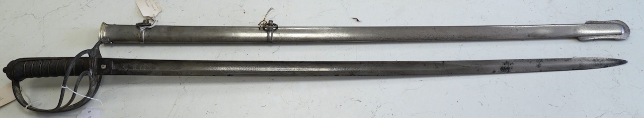 A late Victorian Royal Artillery officer’s sword by Wilkinson, No.25179, etched with regimental device, Royal Arms, owner’s crest and motto, blade 88.5cm. Condition - poor condition in a good scabbard.